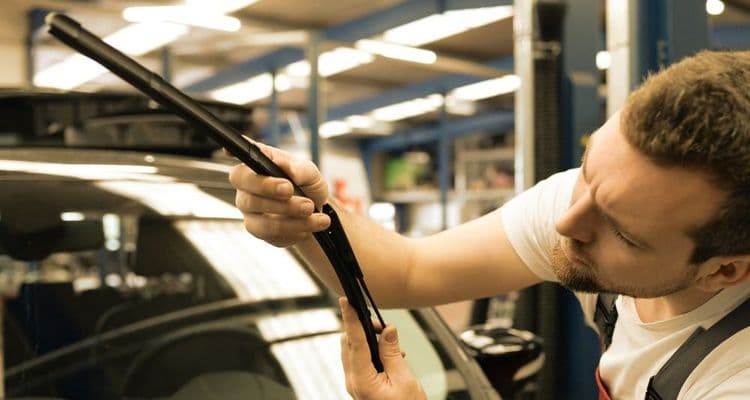 Automotive mechatronics technician checks windscreen wipers