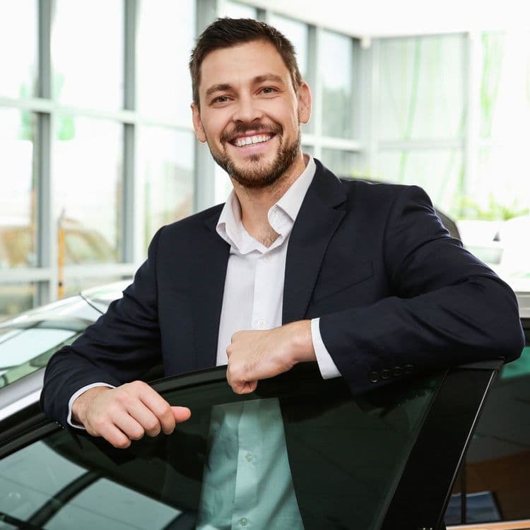 Car salesman smiles