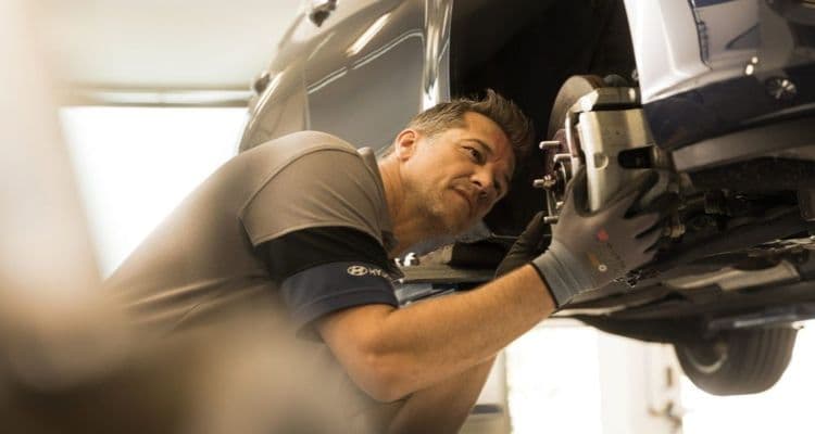 Vehicle mechatronics technician checks brakes