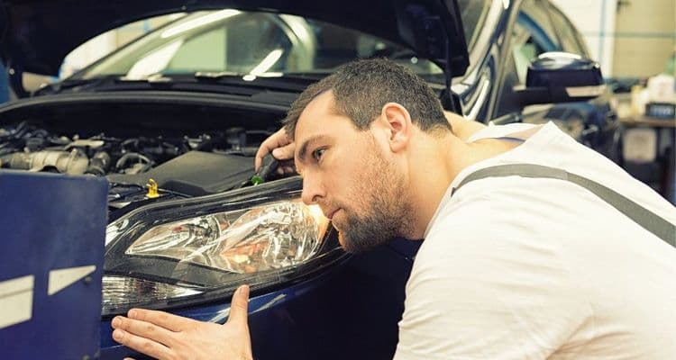 Vehicle mechatronics technician checks lights